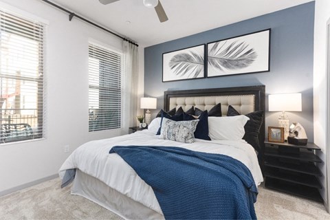 a bedroom with a bed and two windows