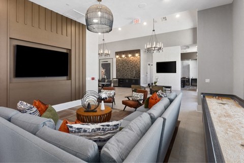 a large living room with couches and chairs and a television