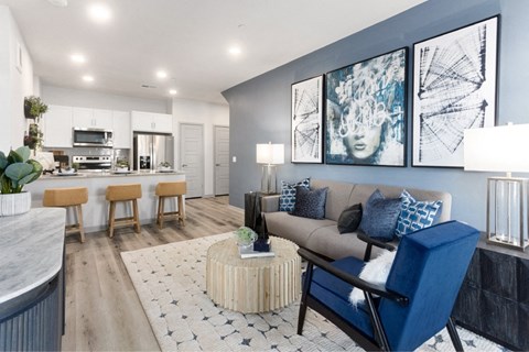 a living room and kitchen with a couch and a table