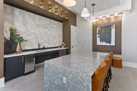 a kitchen with a large marble counter top and a long table