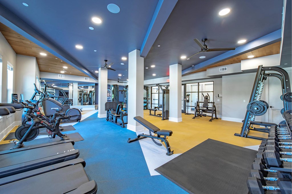 a gym with weights and cardio equipment at the estates estates