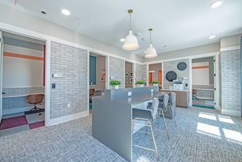 a kitchen and dining area with a long counter and chairs