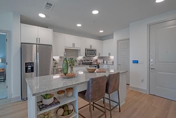 a kitchen with a marble counter top and stainless steel appliances