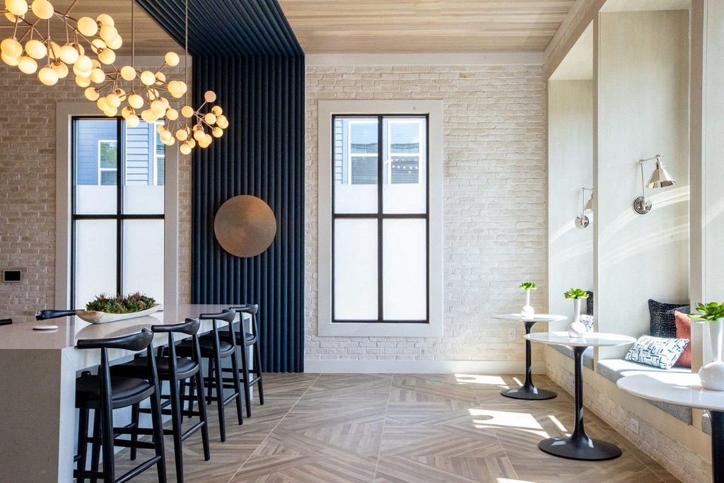 a dining room with black chairs and a long table and a large window