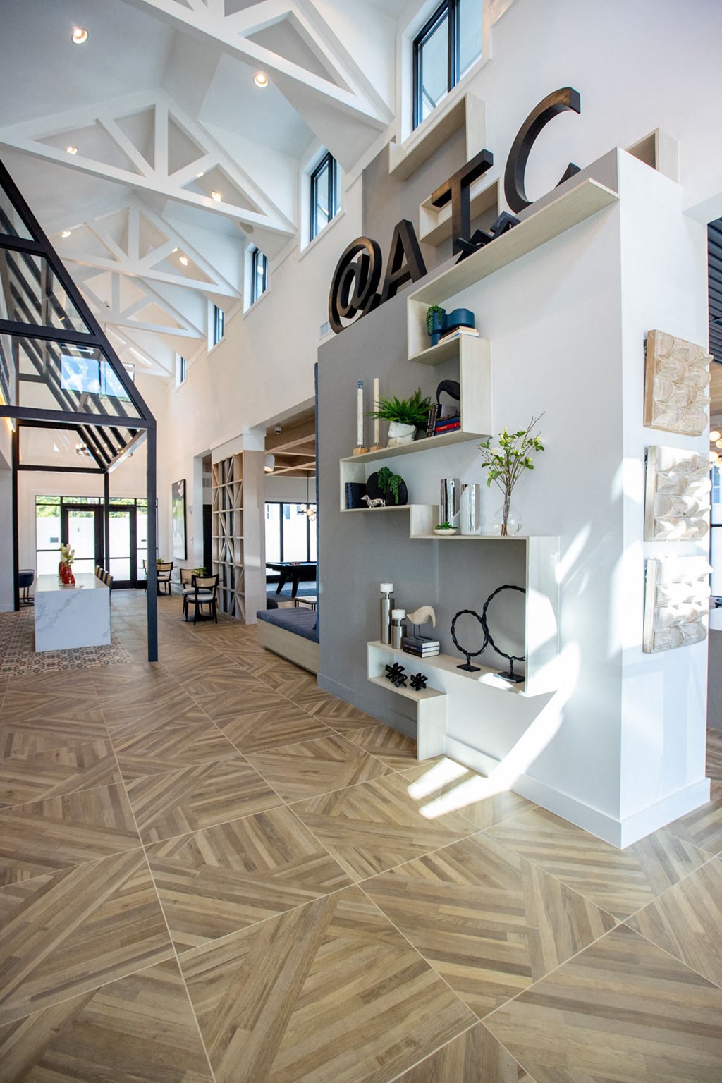a living room with a white wall and a wood floor