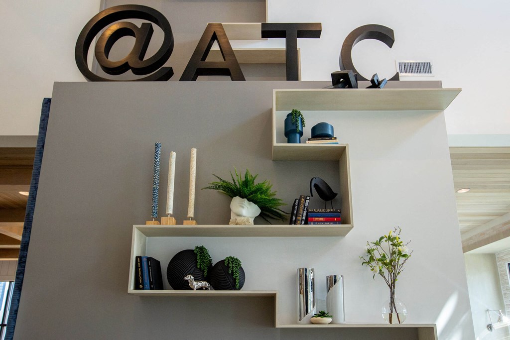 a living room with shelves on the wall