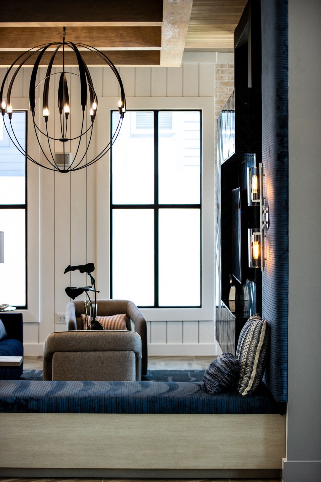 a living room with a couch and chairs and a large window