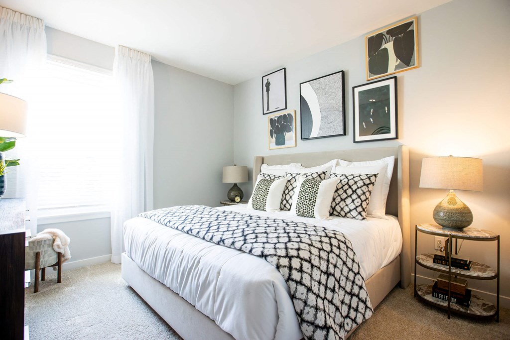 a bedroom with a bed and pictures on the wall