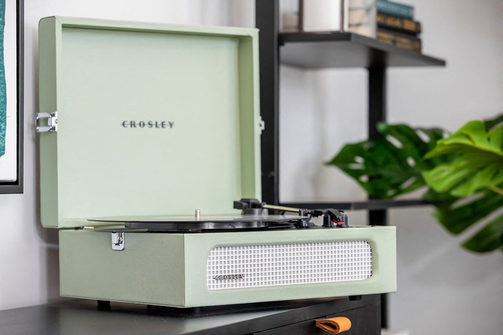 an old radio sitting on a table next to a plant