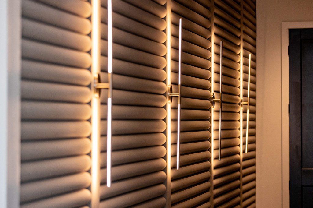 the light shining through the shutters of a window