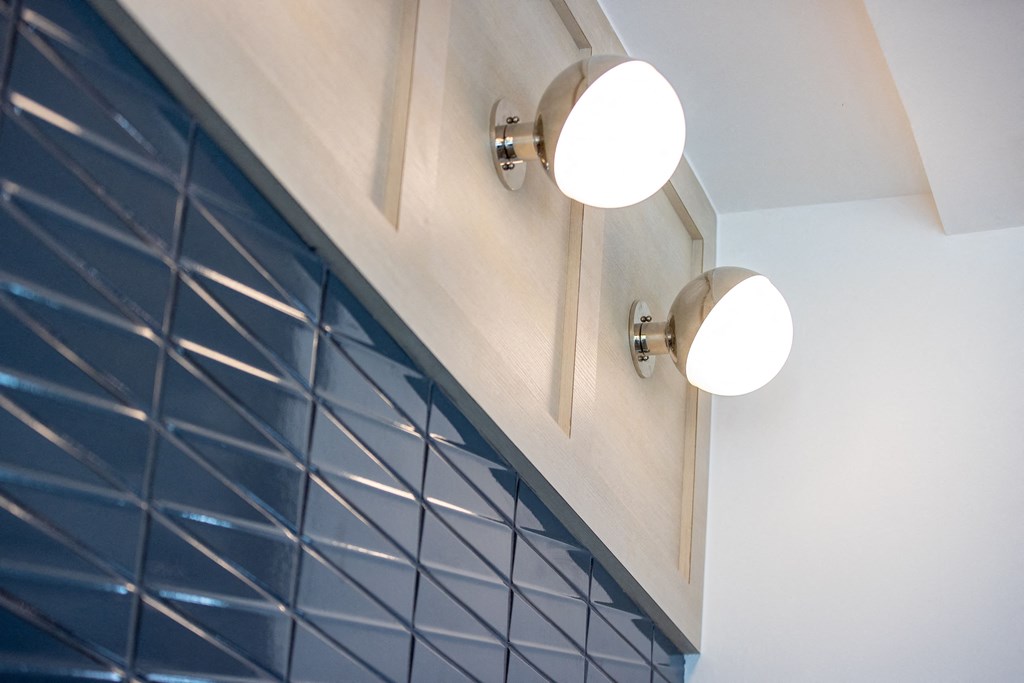 a close up of a cabinet with two lights on it