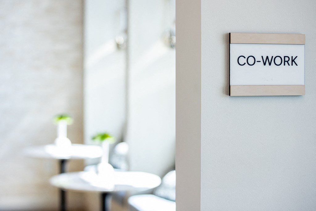 a co work sign on a wall in a restaurant