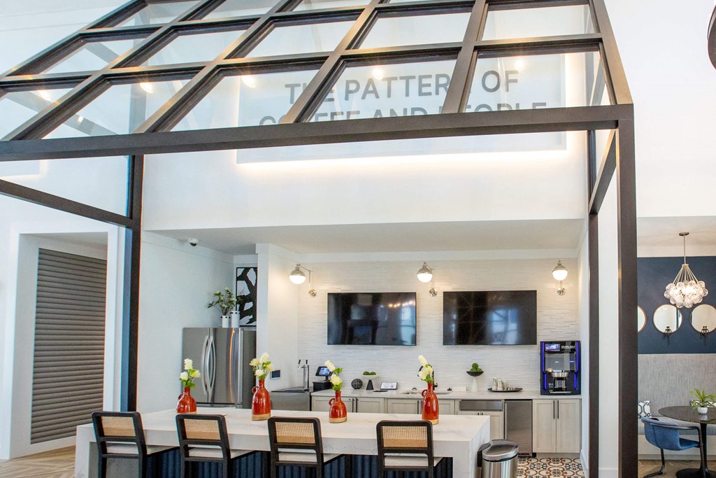the kitchen and dining area of a glass house