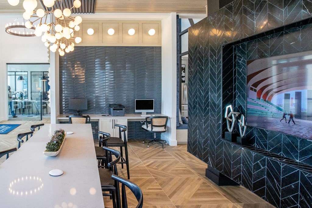 a conference room with a large tv and a table with chairs