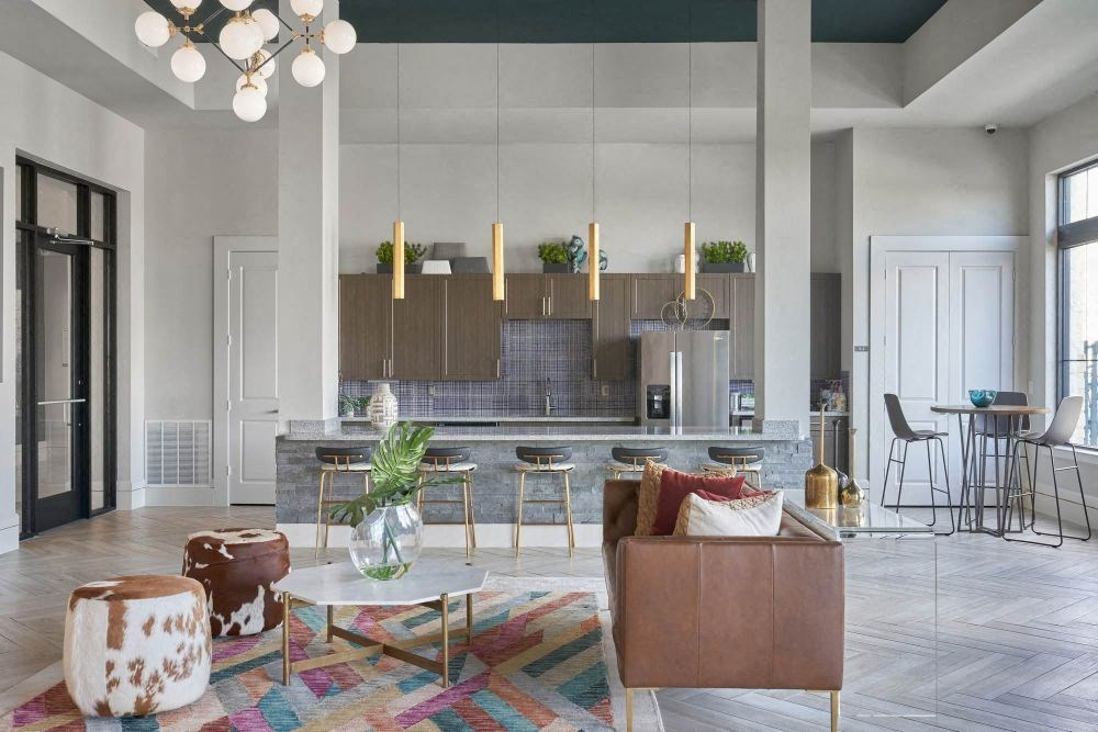 a large living room with a kitchen in the background