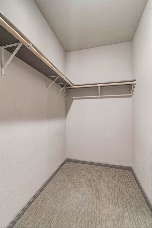 an empty room with a white wall and a closet