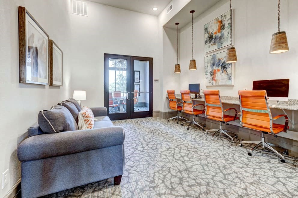 a conference room with a couch and chairs and a desk