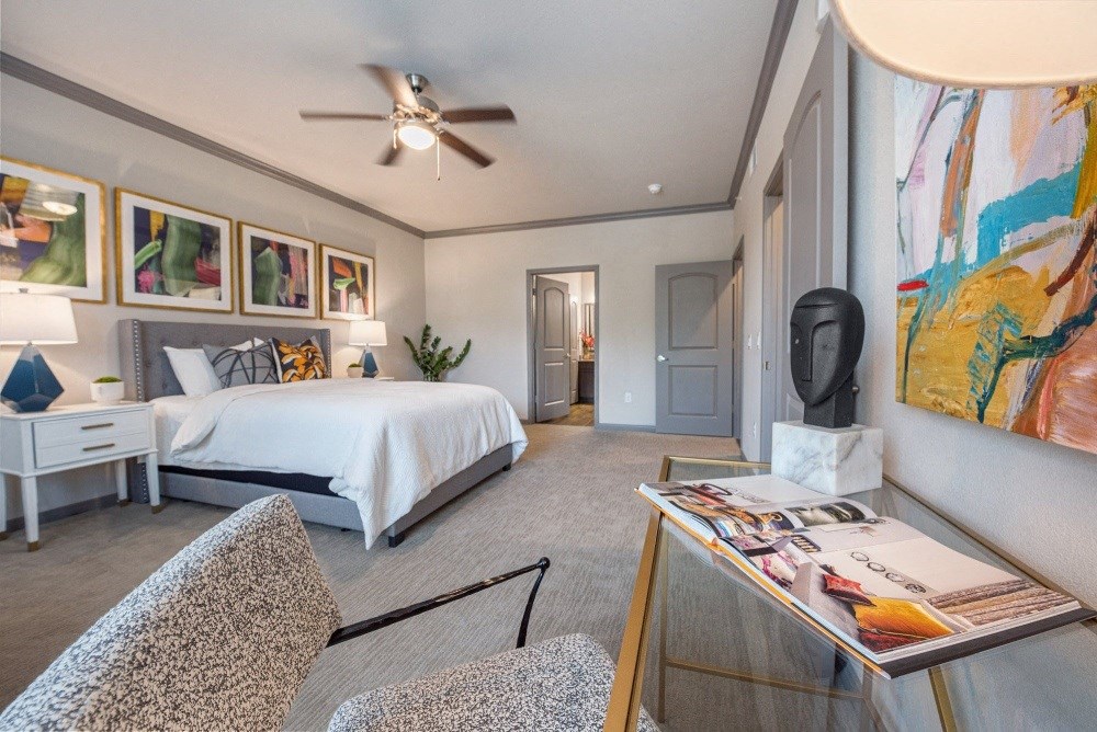 a bedroom with a large bed and a ceiling fan