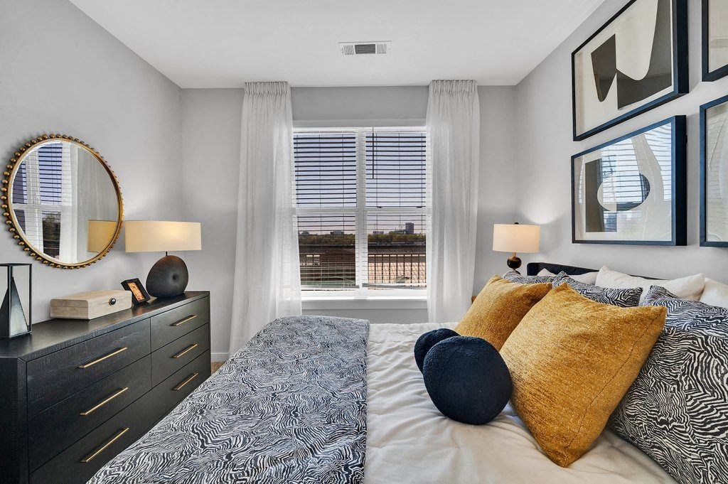 a bedroom with a large bed and a window