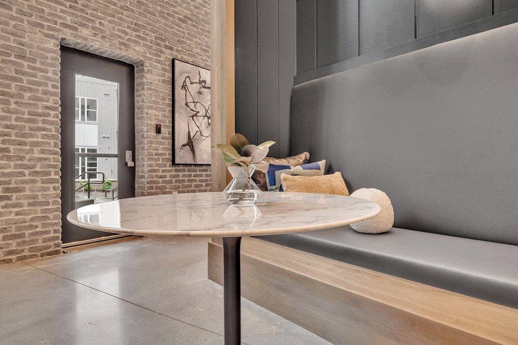 a living room with a round table and a couch