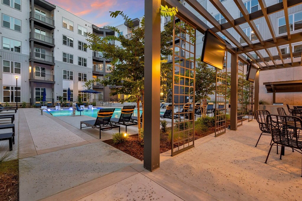 apartments with a pool and patio at dusk