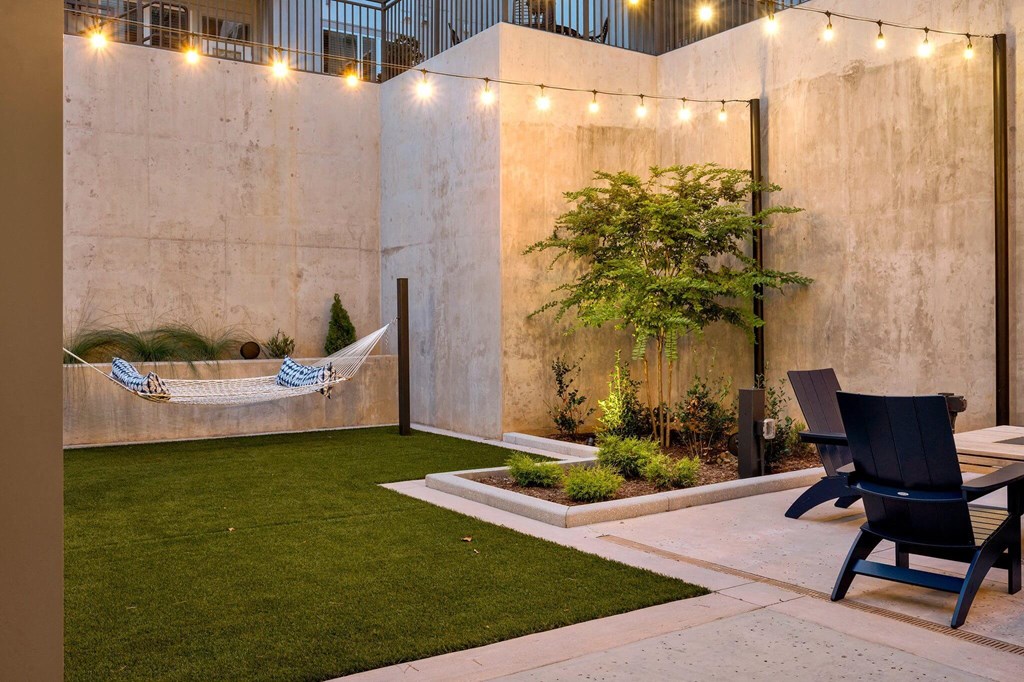 a courtyard with a hammock hanging on the wall