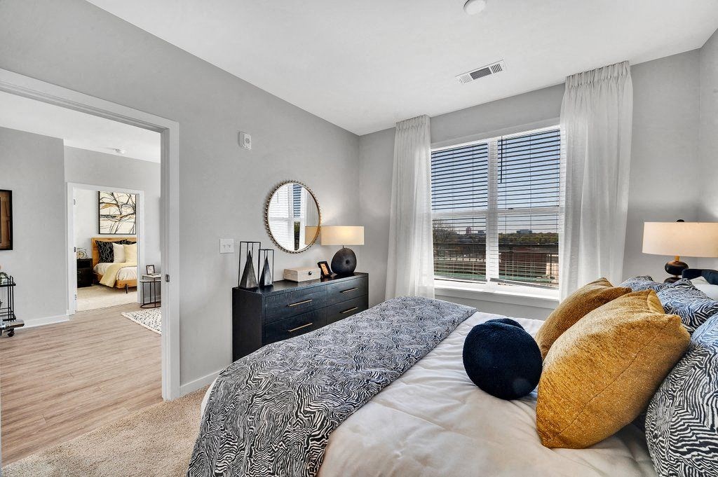 a bedroom with a large bed and a window