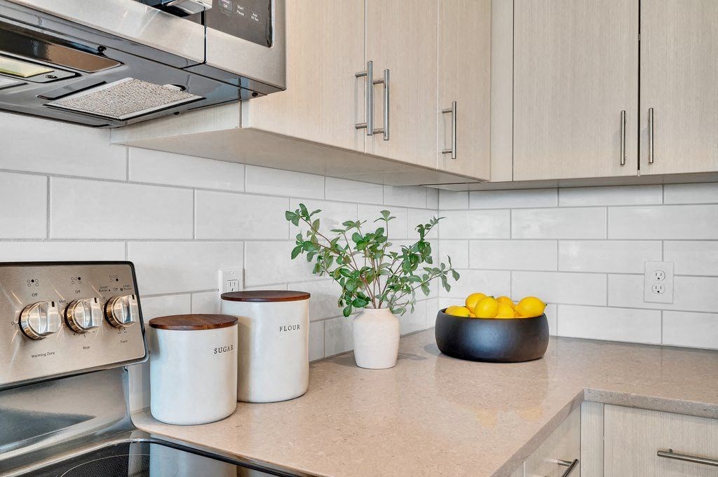 a kitchen counter with a bowl of fruit on it