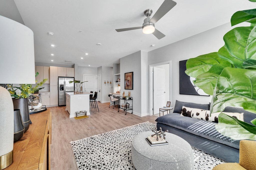 a living room with a couch and a ceiling fan