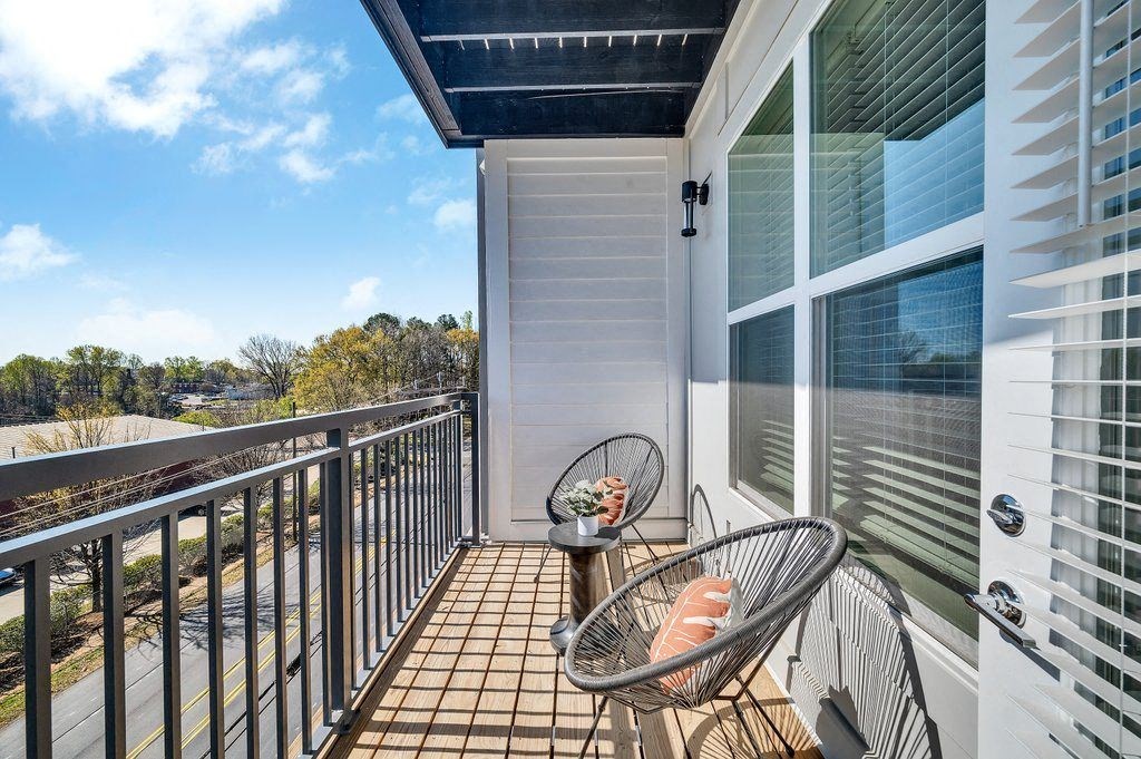 a balcony with two chairs and a view of the ocean