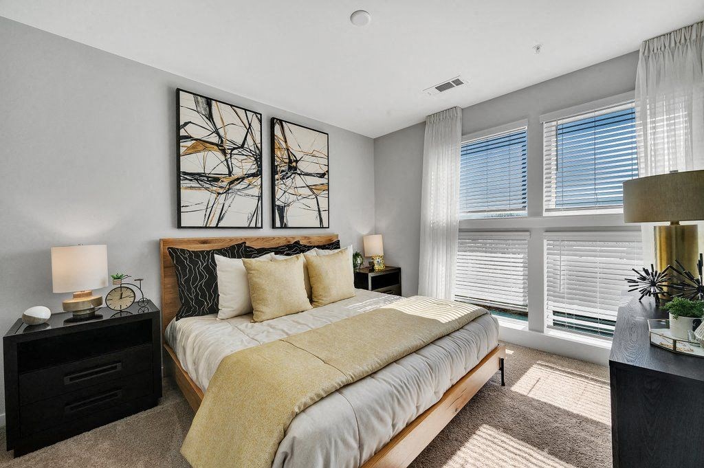 a bedroom with a bed and some windows