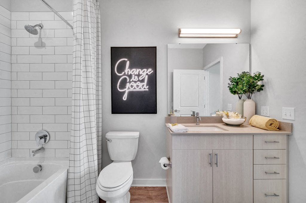 a bathroom with a sink toilet and a bath tub