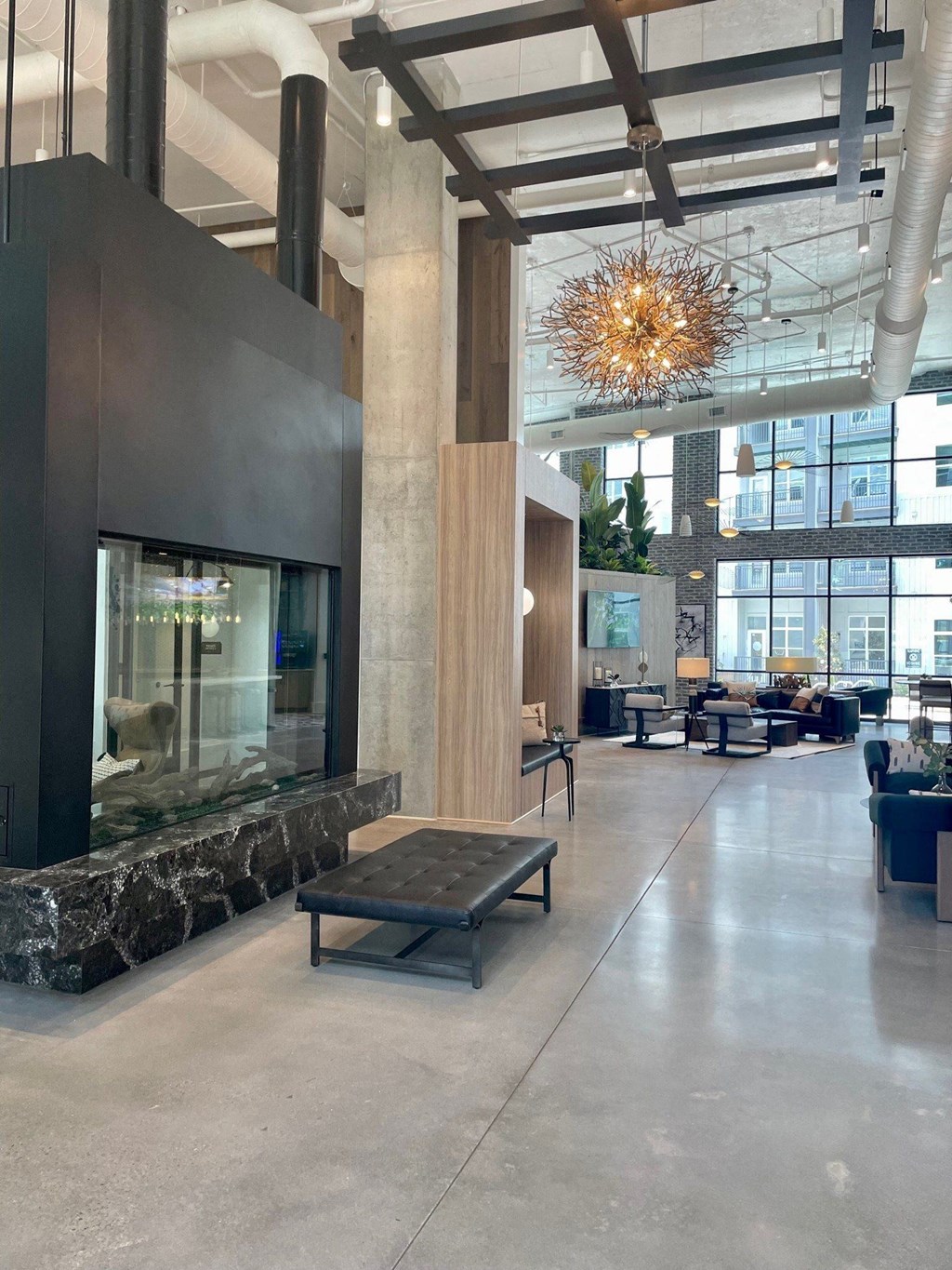 a large lobby with a fireplace and a large chandelier