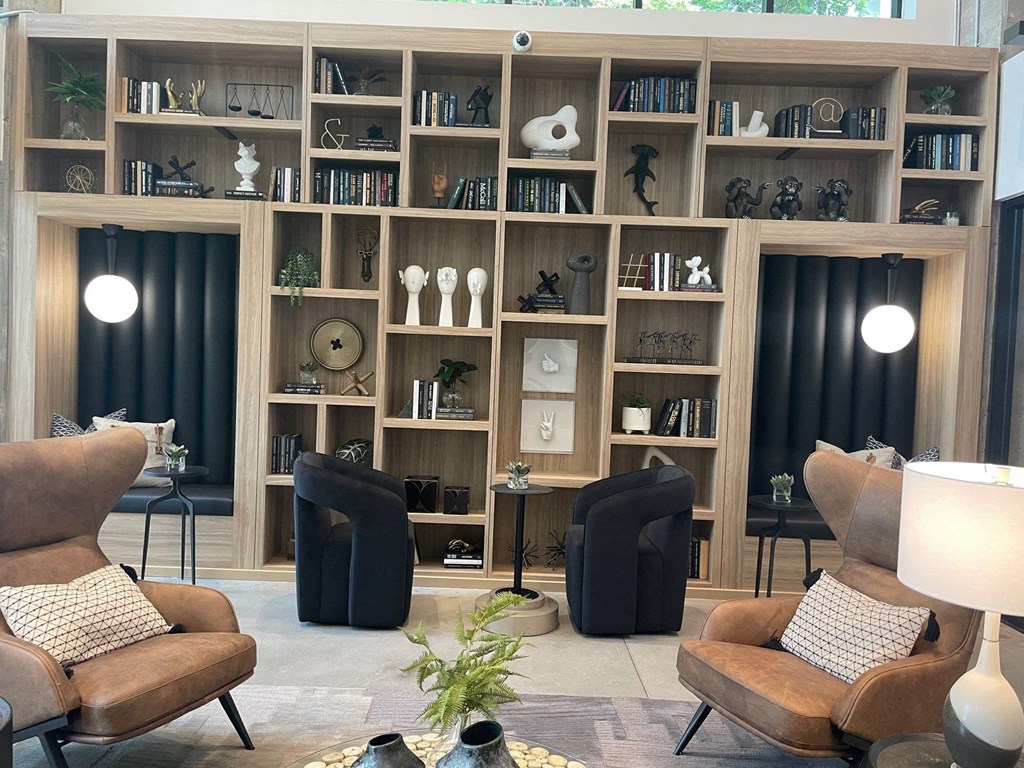 a living room filled with furniture and a book shelf
