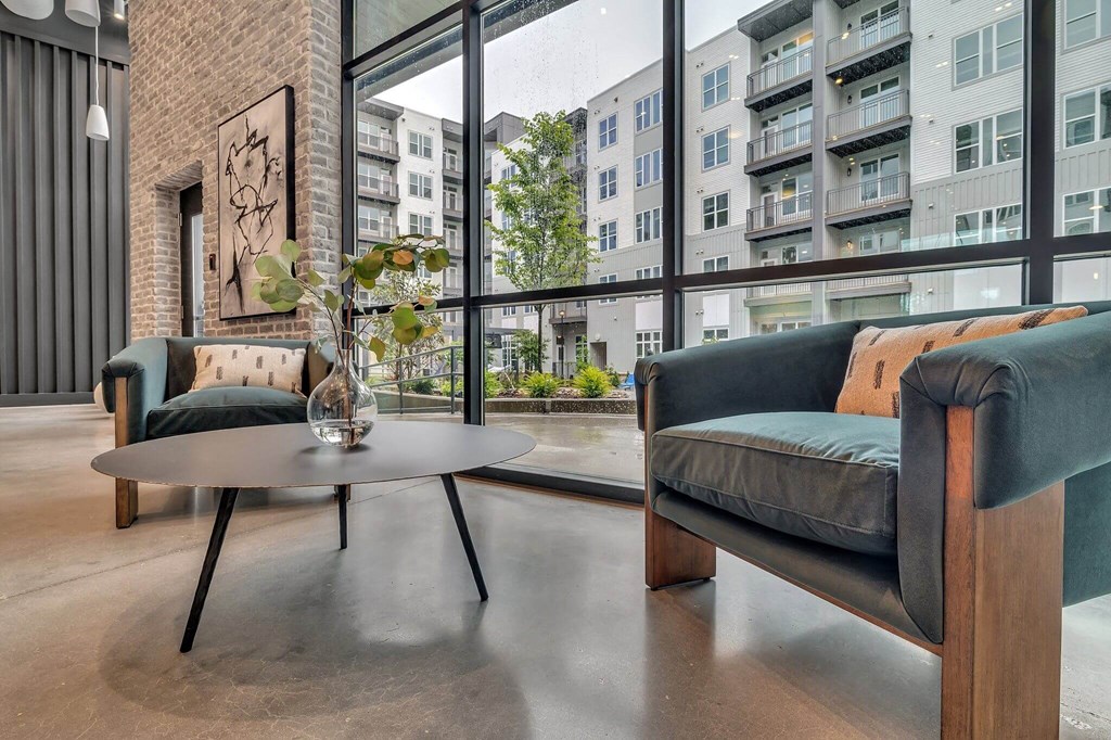 a living room with a couch and a table in front of a window