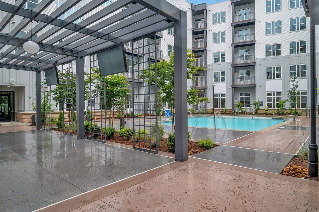 an empty pool in front of an apartment building