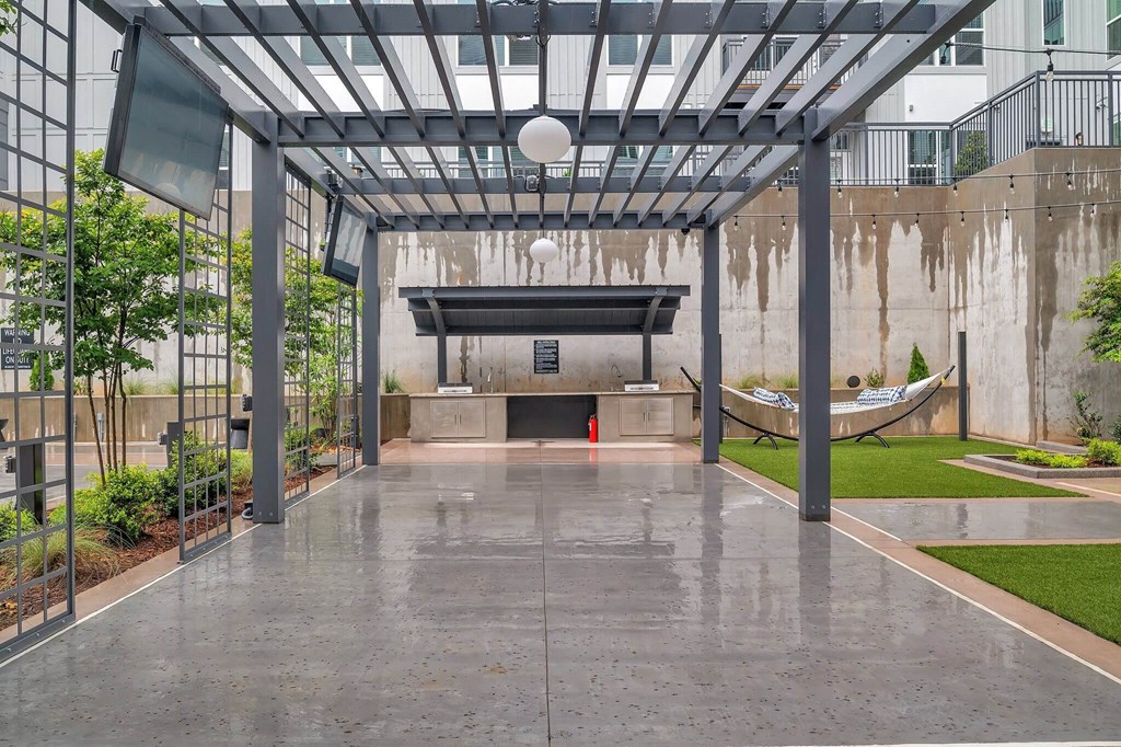 the lobby of a building with a pool and a hammock