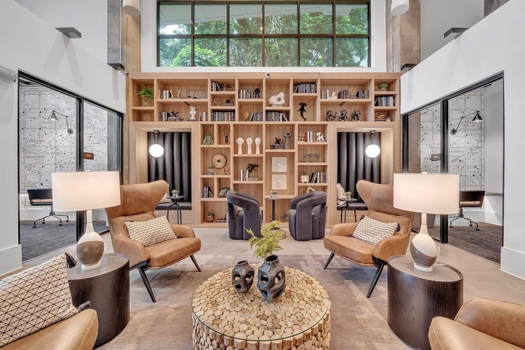 a living room filled with furniture and a book shelf