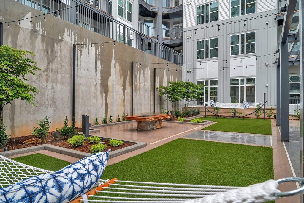 a courtyard with a bench and grass