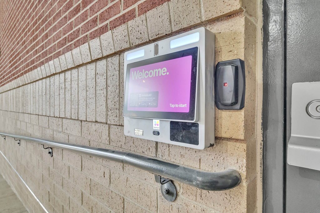 a welcome sign on the side of a brick building
