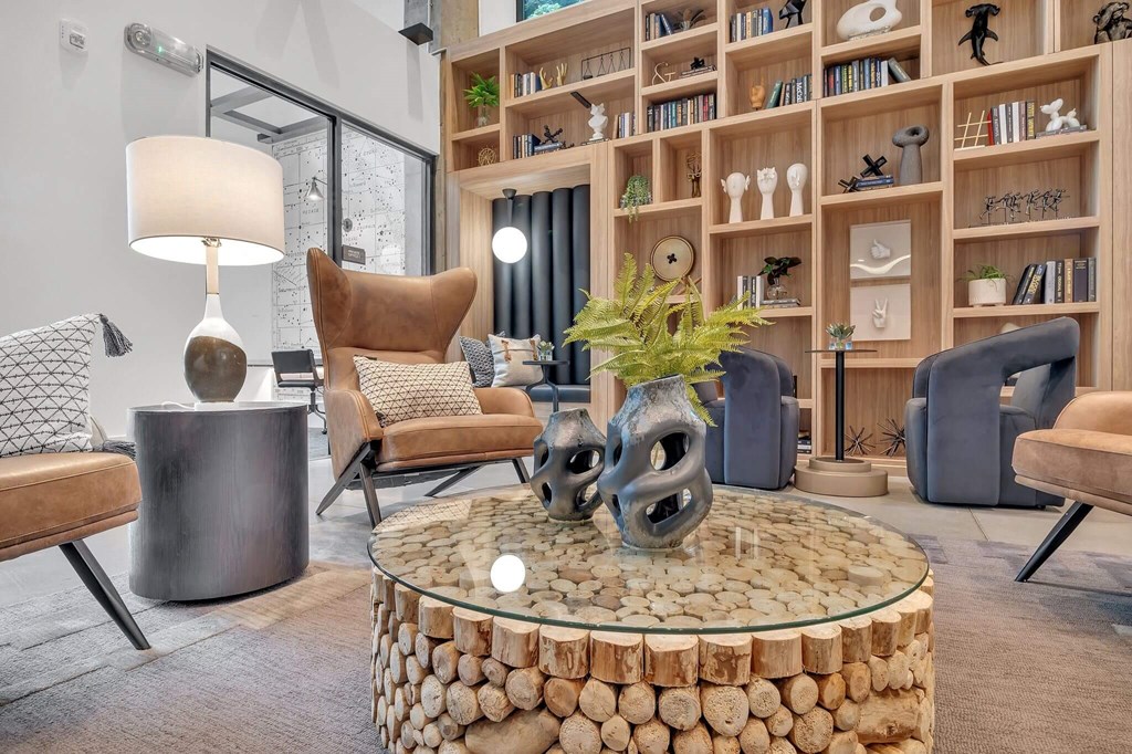 a living room filled with furniture and a large book shelf