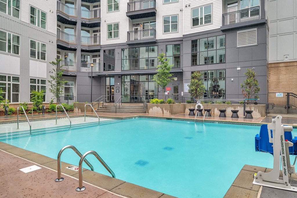 a swimming pool in front of an apartment building