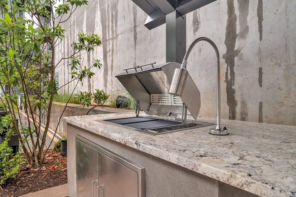 a kitchen counter with a sink and a faucet