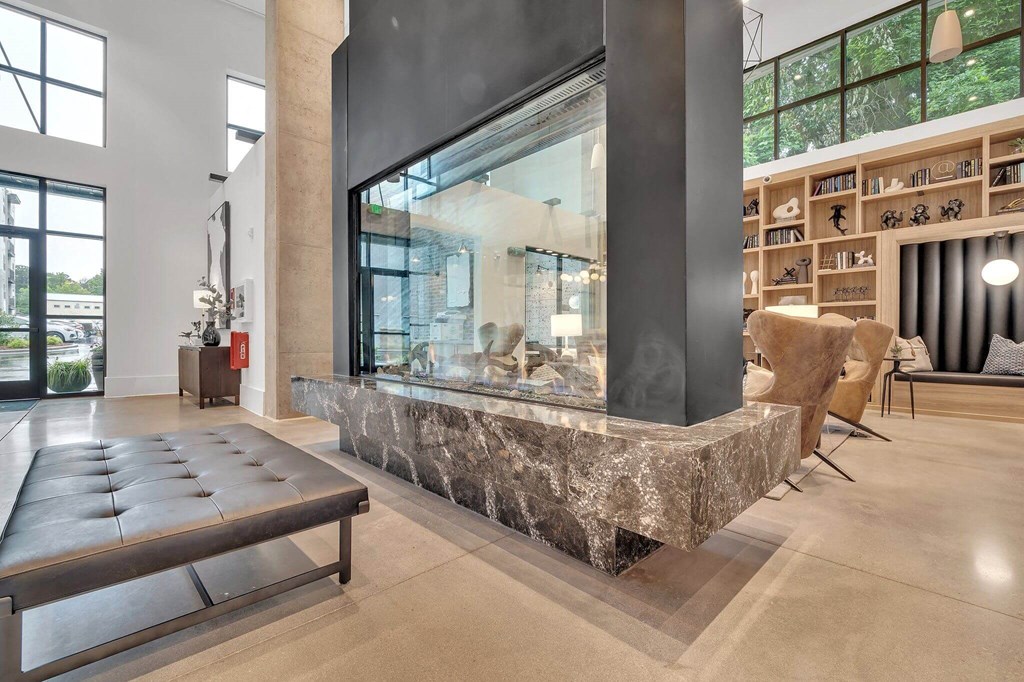 the lobby or reception area of a house with a large fireplace