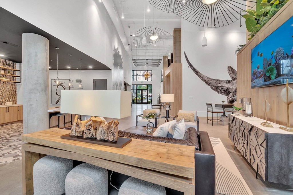 a living room with a wooden table and a whale painting on the wall