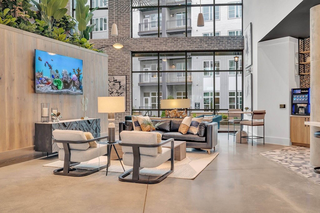 a living room with couches and chairs and a tv