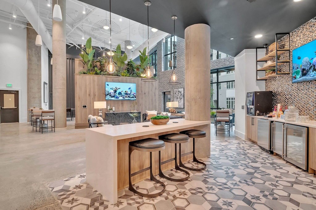 a kitchen with three stools in front of a counter top