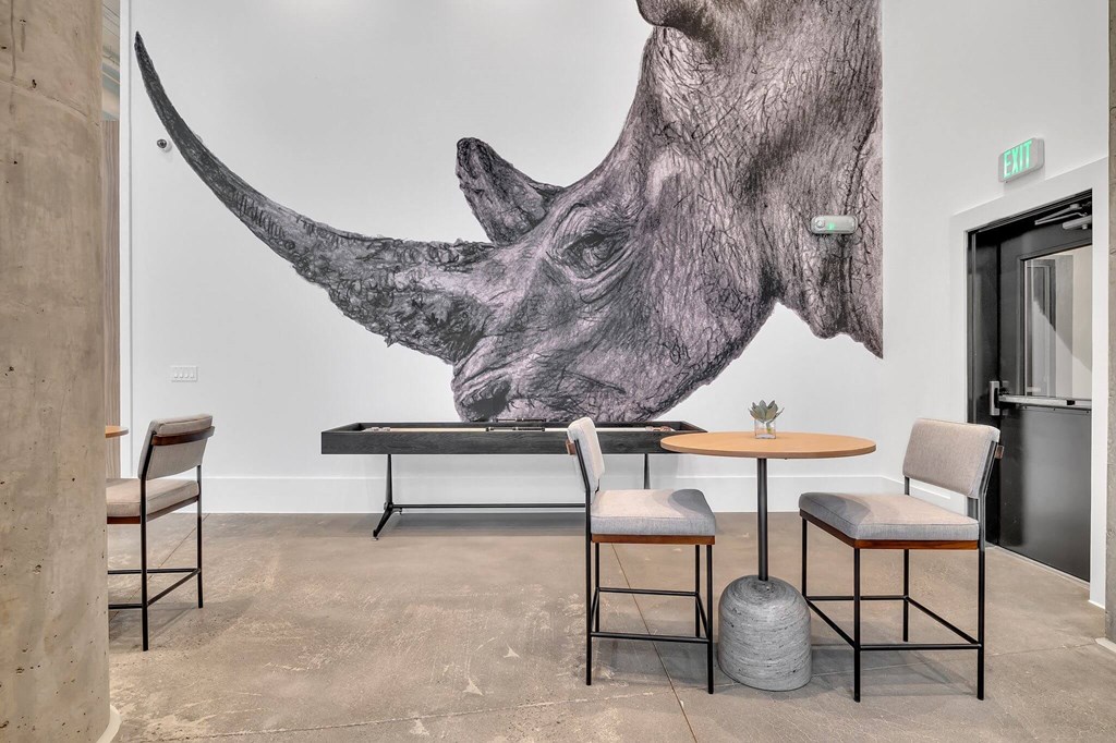 a restaurant with a mural of a rhino on the wall