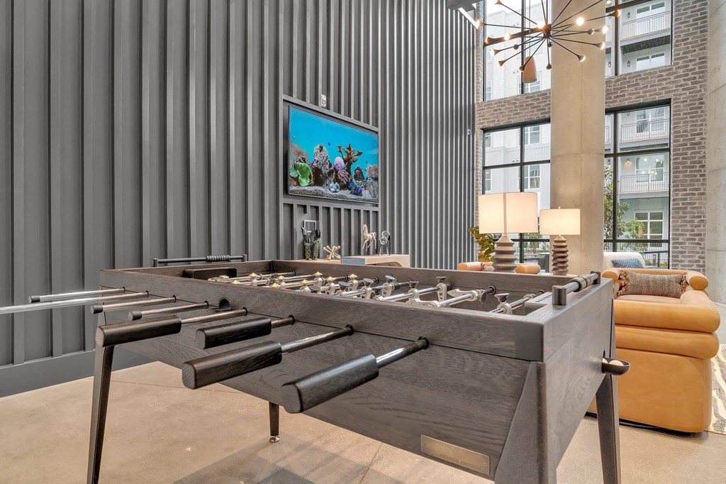 a foosball table in a living room with a couch