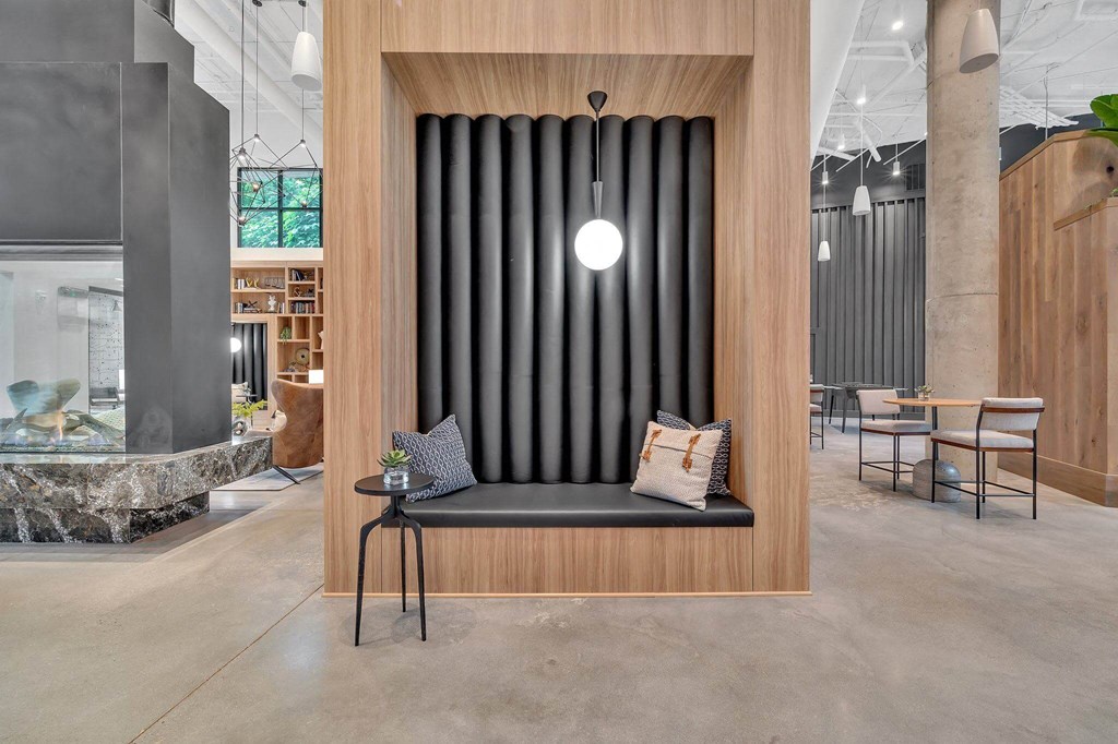 a bench with pillows in a room with a table and chairs